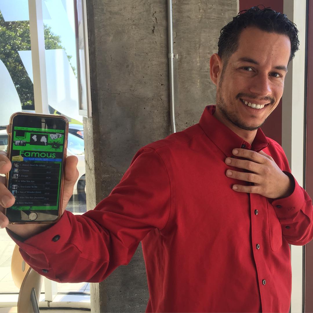 A new fan displays The Band Famous app on their phone at Capital One Cafe in Los Angeles.